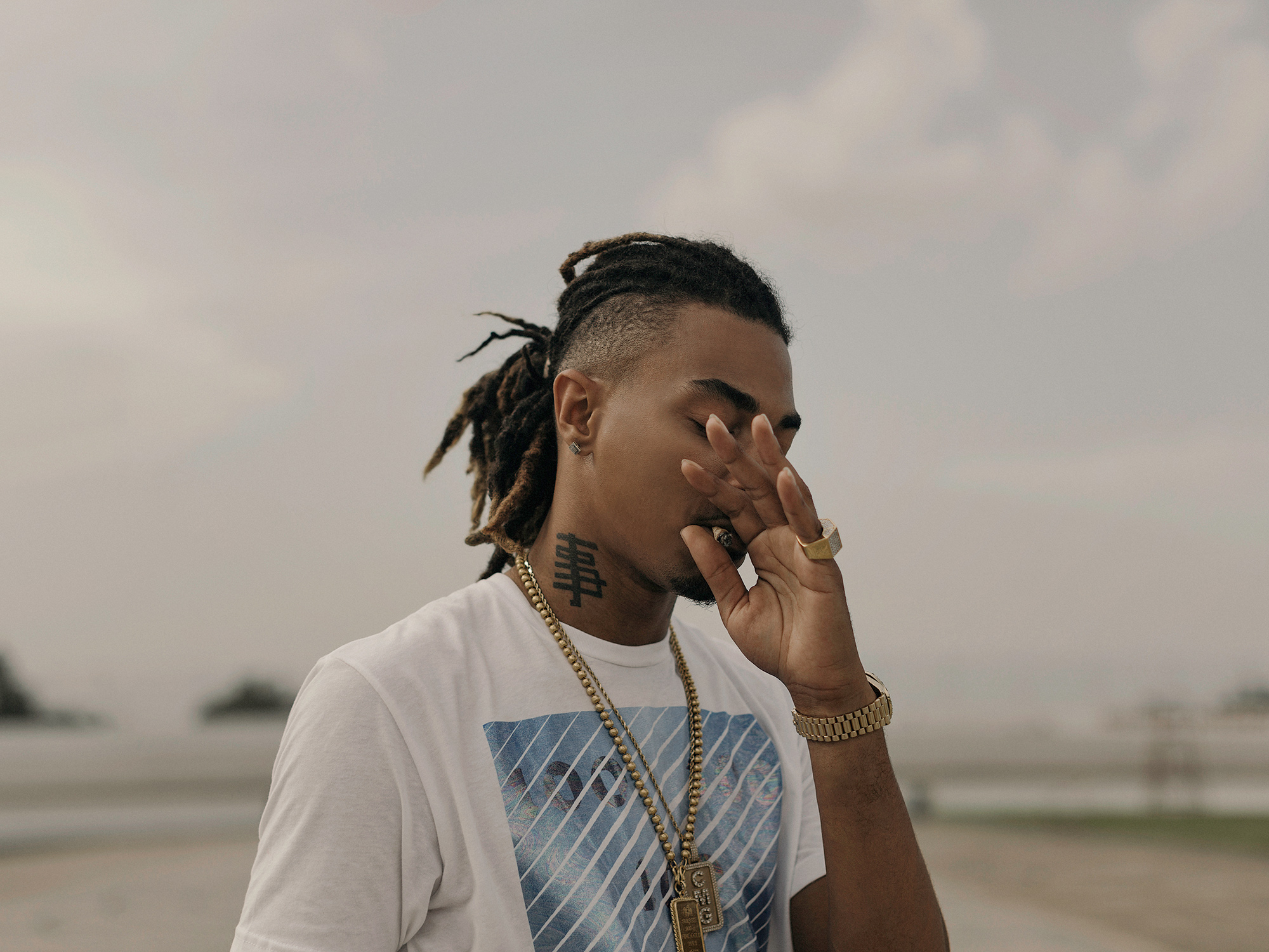 Snootie Wild, Memphis hip hop artist and rapper, takes a drag from a blunt, while filming a music video in Houston, Texas, photographed by Houston editorial and commercial photographer, Todd Spoth.