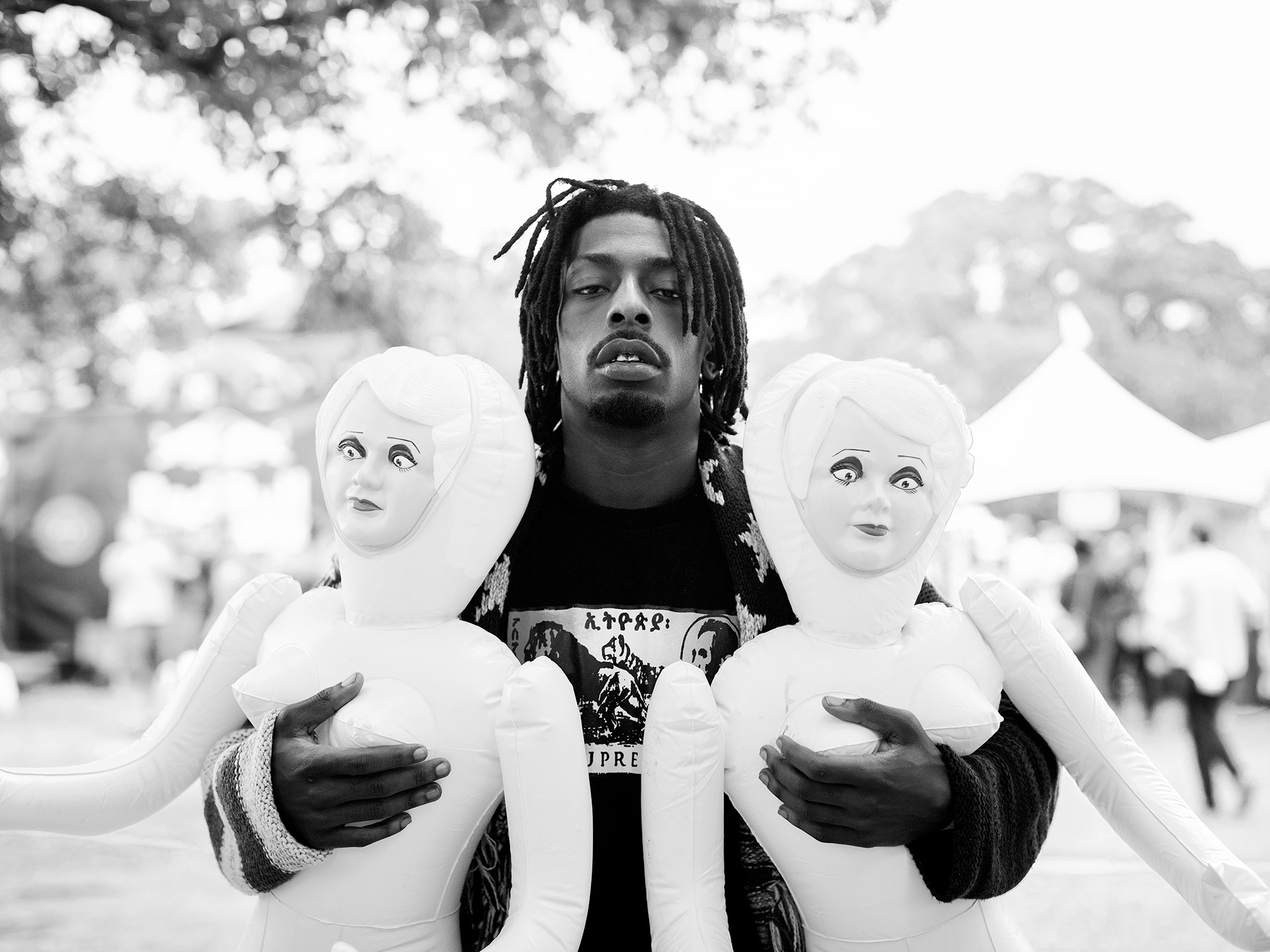 Meechy Darko, rapper and member of Flatbush Zombies, holds two blow up dolls backstage during the Fun Fun Fun Fest music festival, photographed by Houston music and entertainment photographer, Todd Spoth.