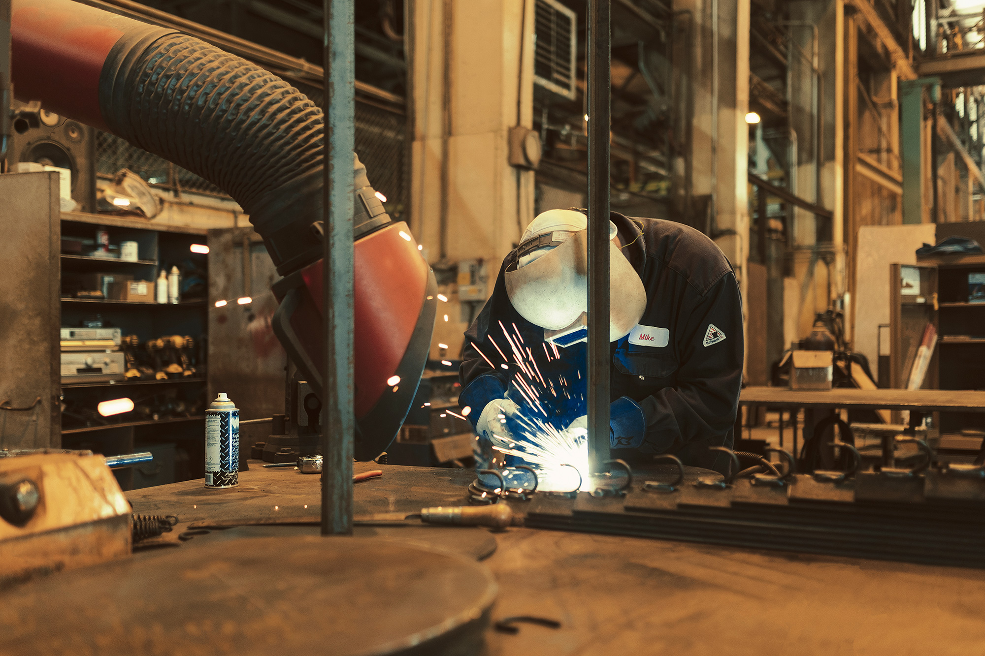 An Exxon Mobil employee welds in the shop on location in Beaumont, Texas photographed by photographer, Todd Spoth.