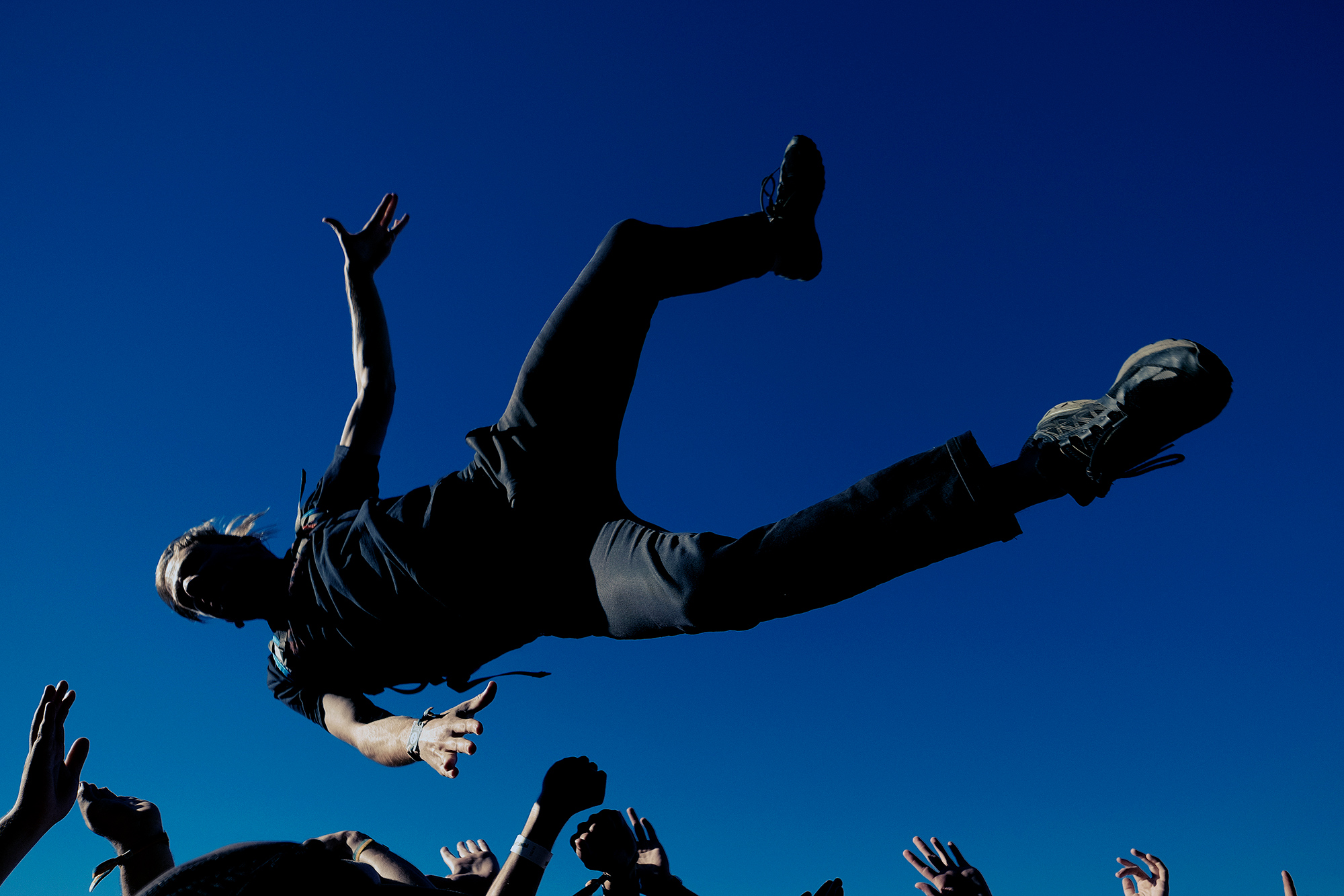 A metal head stage dives during the Fun Fun Fun Fest music festival in Austin, Texas photographed by music photographer, Todd Spoth.