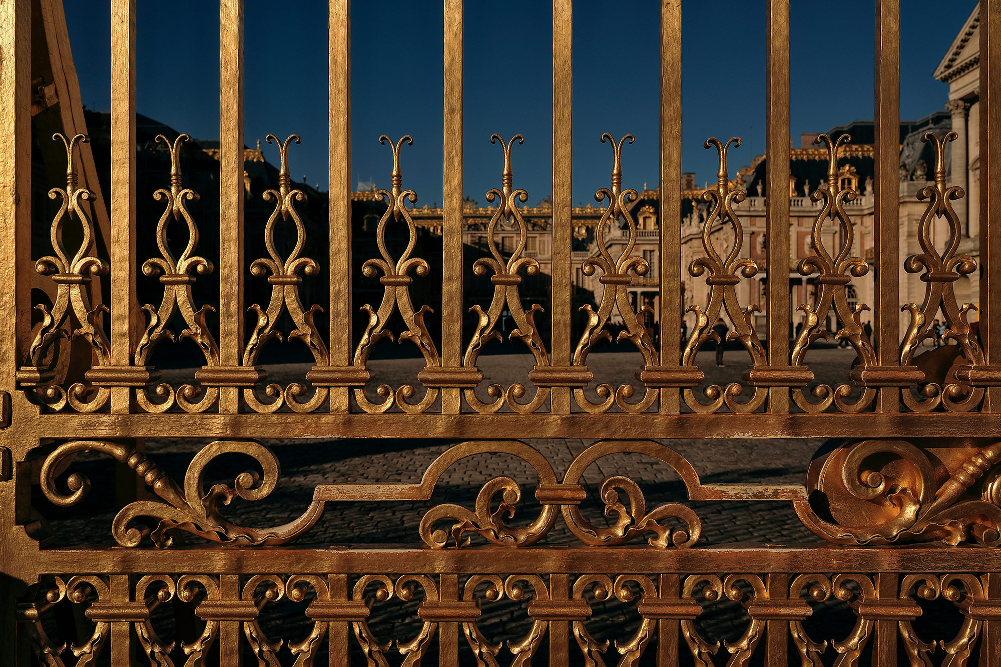 The gold-gilded gates of Versailles outside of Paris, France, photographed by travel photographer, Todd Spoth.