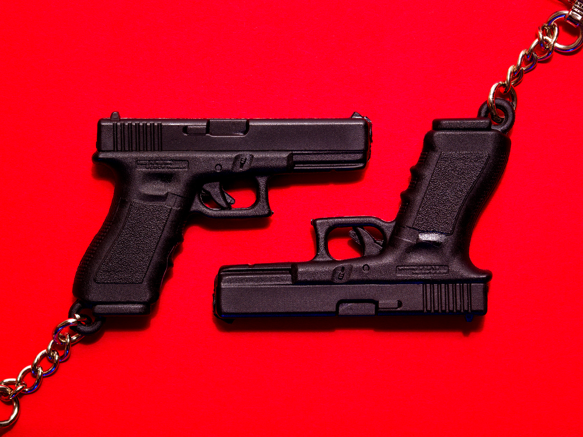 A pair of promotional keychains from the Glock company, photographed in studio by Todd Spoth.