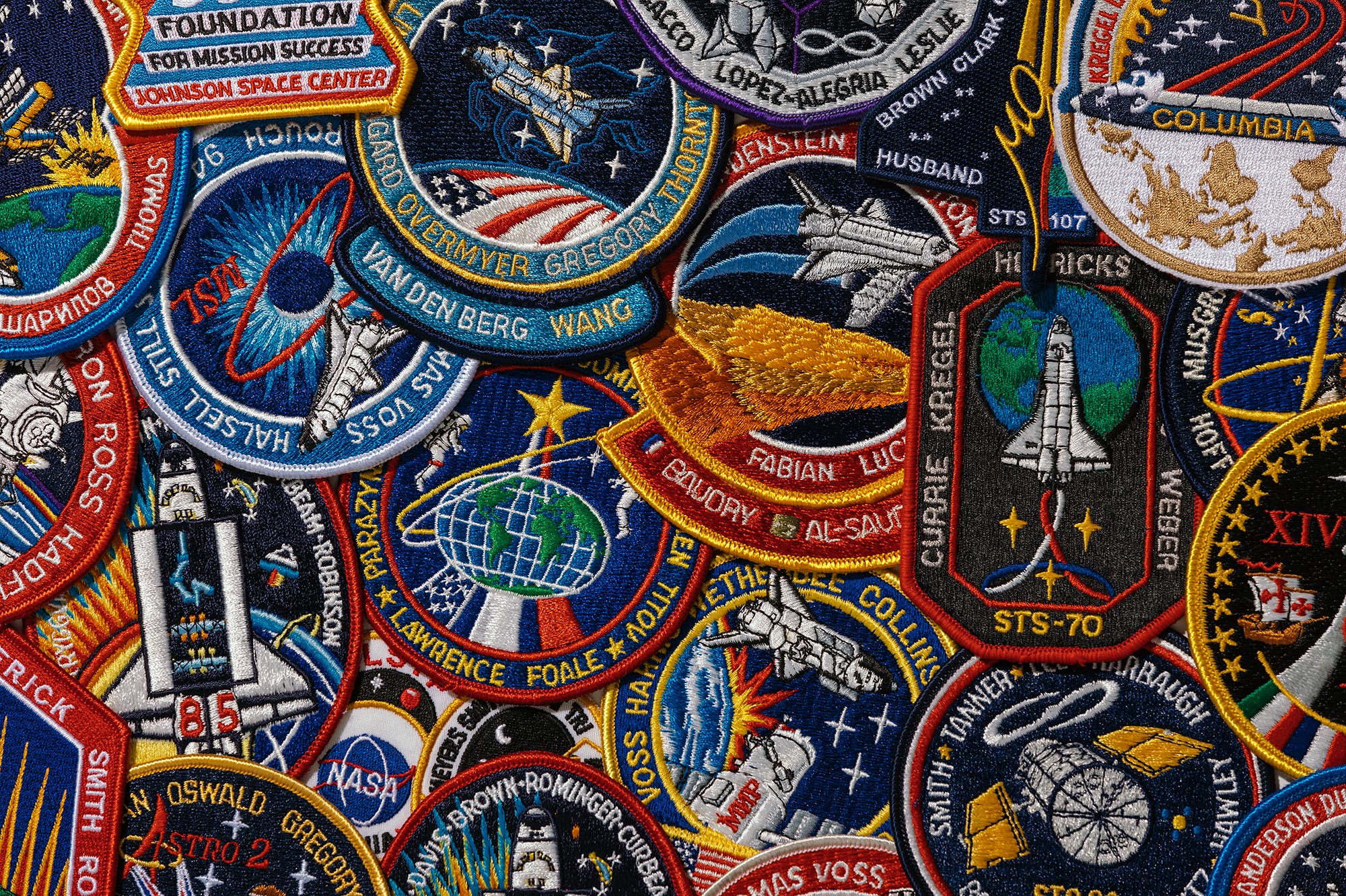 A grouping of space-flown official mission patches from past NASA space missions owned and photographed by Todd Spoth.